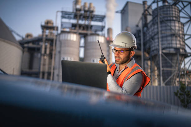 istock Engineer working with laptop and report a problem on walkie talkie. 2166421922