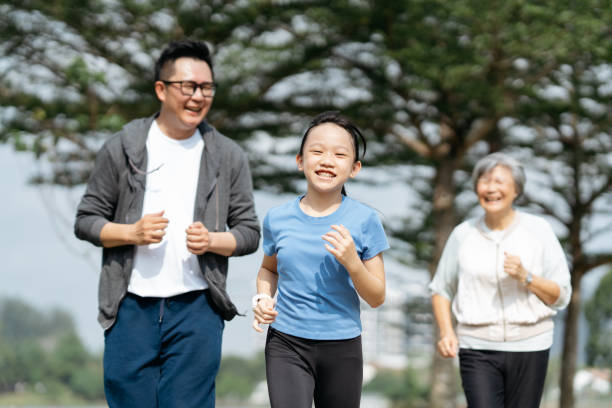 istock Multi-generation family running in park 2166422019