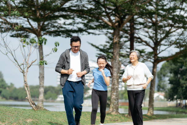 istock Three generation family running in the park 2166422020