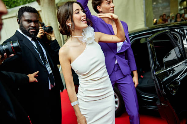 istock Celebrity couple waving at fans 2166422549