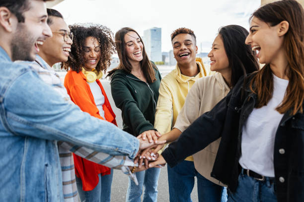 istock Diverse teenage student friends stacking hands showing teamwork and cooperation 2166425543