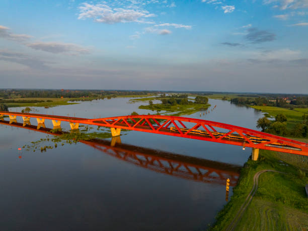 istock Train bridge in a colorful sunset over the river IJssel 2166428049
