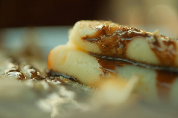 A stack of pancakes with syrup on top. The pancakes are stacked on top of each other and the syrup is dripping down the side. Concept of indulgence and comfort