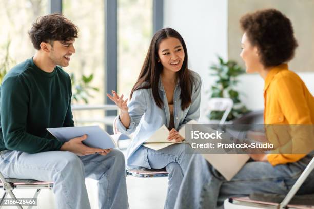 Group Study Live Multiracial Students Discussing Notes In Lively Group Study Session ...