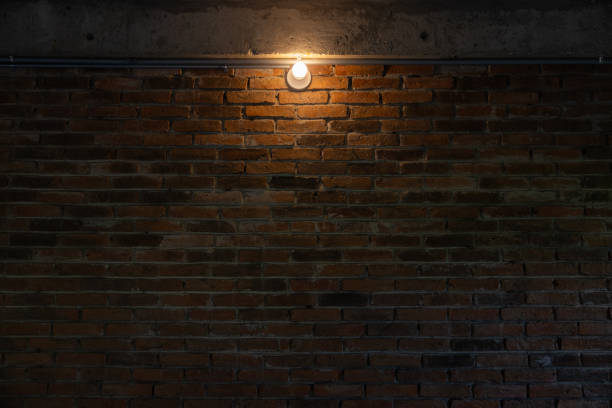 istock A brick wall with a light shining on it. a vintage light on brick wall in underground room. 2166428603
