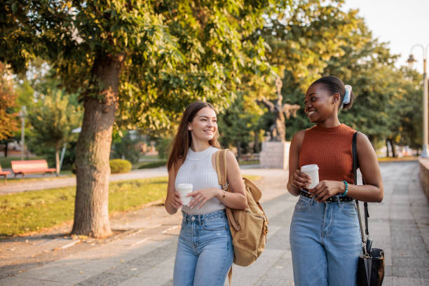 istock Young female friends walking in a park 2166433307