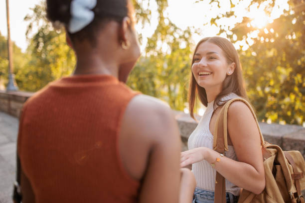 istock Two young friends talking outdoors 2166433330