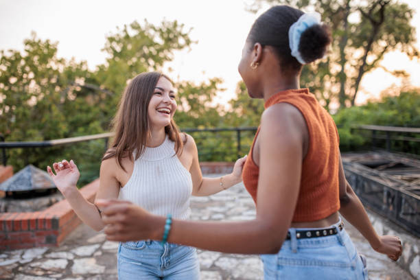 istock Two young women dancing in a park 2166433531