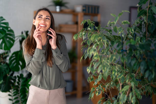 istock Joyful Woman Engaged in Phone Conversation at Work 2166433590