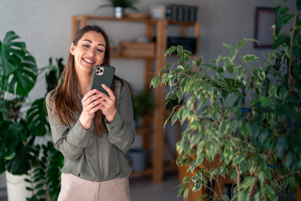 istock Professional Woman Engaging with Smartphone in Home Office 2166433593
