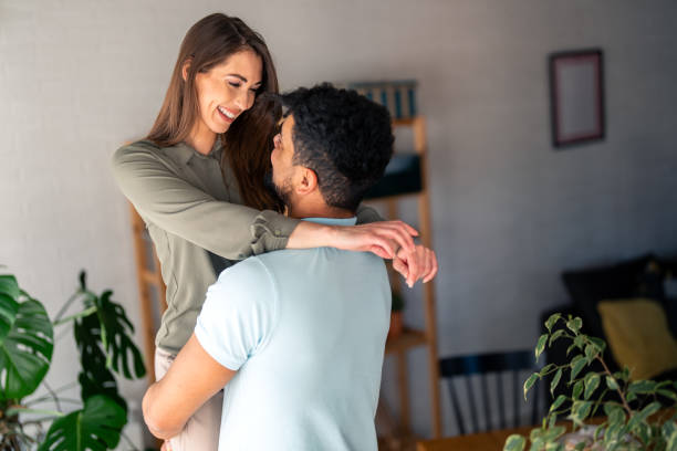 istock Affectionate Embrace with Diverse Young Couple Indoors 2166433656