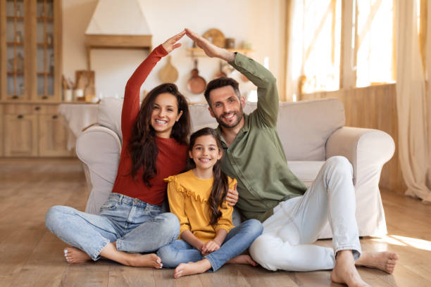 istock Family making a home shape with arms and hands 2166434829
