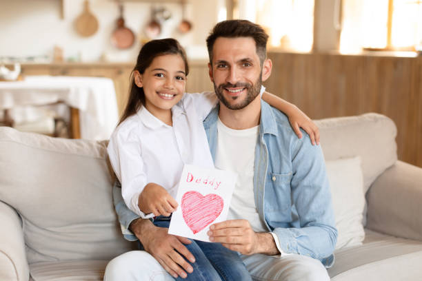 istock Father and daughter sharing a handmade card 2166434859