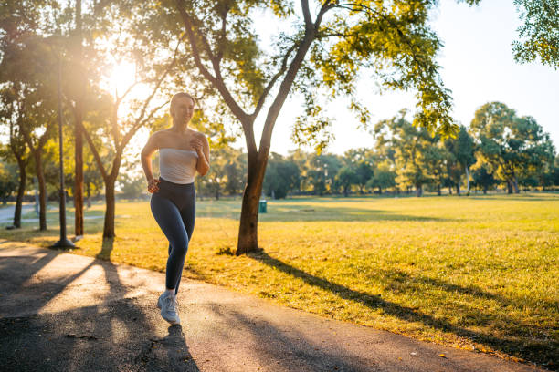 istock Young Woman Jogging Outdoors In A Park 2166437251