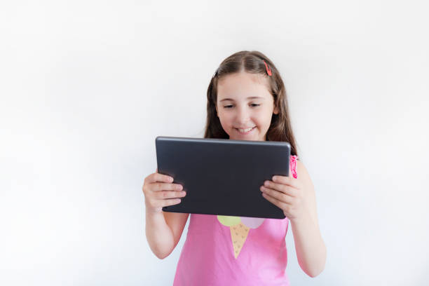 Shot of a little kid using a digital tablet with tablet computer on green background with copy space.