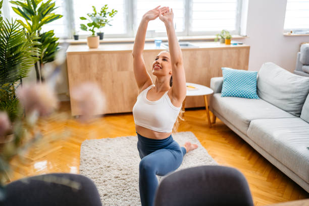istock Young Woman Stretching Before Exercising At Home 2166438178