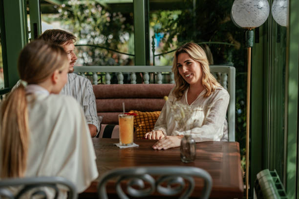 istock Gorgeous blonde in a cafe with two friends 2166438441