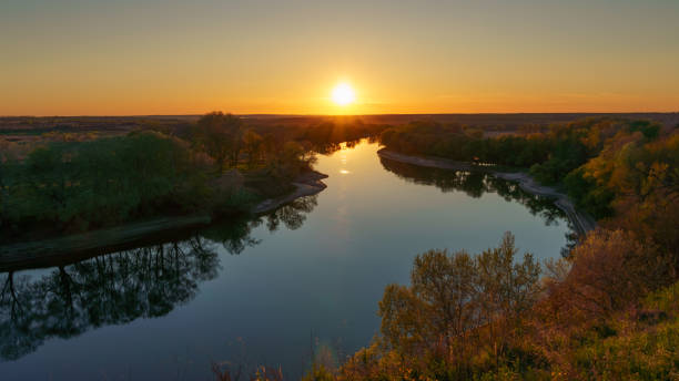 istock beautiful spring landscape, panoramic view of river and forest from above the hill, bright sunny day turns into sunset and dusk, sunlight reflects from water, river bank and flow of water 2166438533