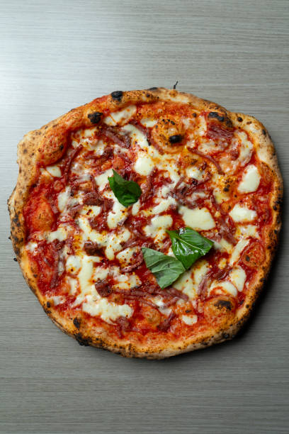 istock Pizza with tomato mozzarella and spicy salami from above 2166443842
