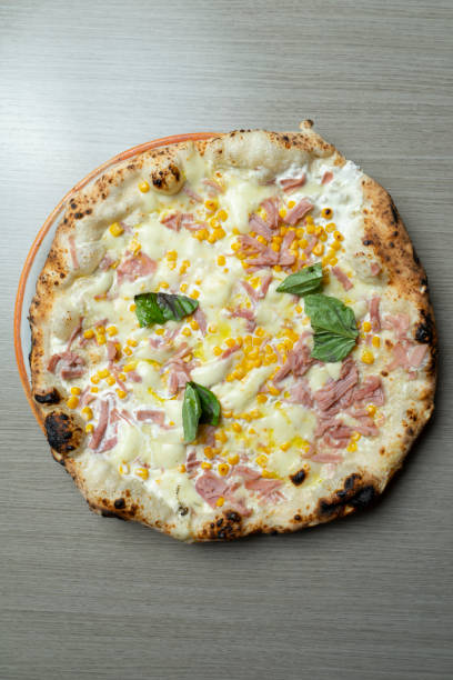 istock Pizza with cream, ham and corn from above 2166443855