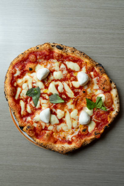 istock Margherita pizza with tomato and whole mozzarella from above 2166443910