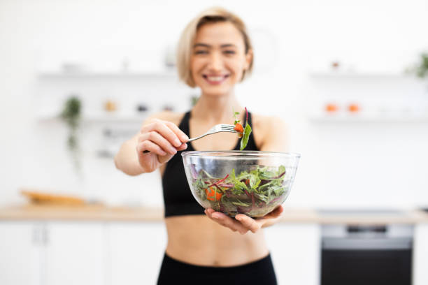 istock Woman enjoying fresh salad in modern kitchen 2166448774
