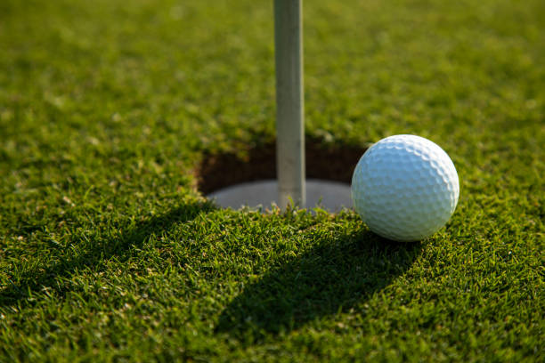 istock Closeup Golf ball on green grass on course 2166449704