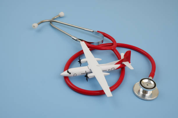 istock Airplane with red stethoscope on blue background. 2166450604