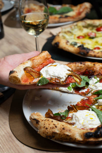 istock Hand holding a slice of Neapolitan pizza 2166452908