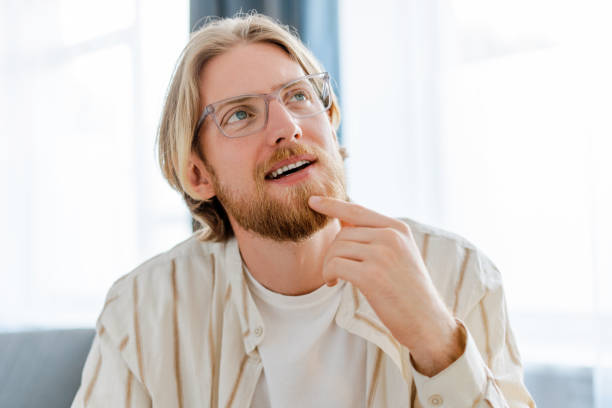istock Pensive male freelancer thinking and looking up indoors 2166459058