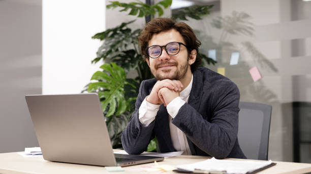 istock Focused trader working on a laptop in a modern office, analyzing market trends and planning investment strategies. Perfect for illustrating financial growth and professional trading. 2166461812