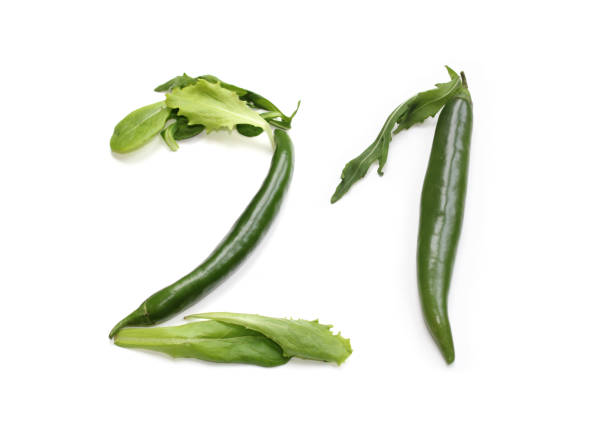 istock green anniversary number 21, twenty one, from chilli pepper and salad lettuce leaf 2166463012