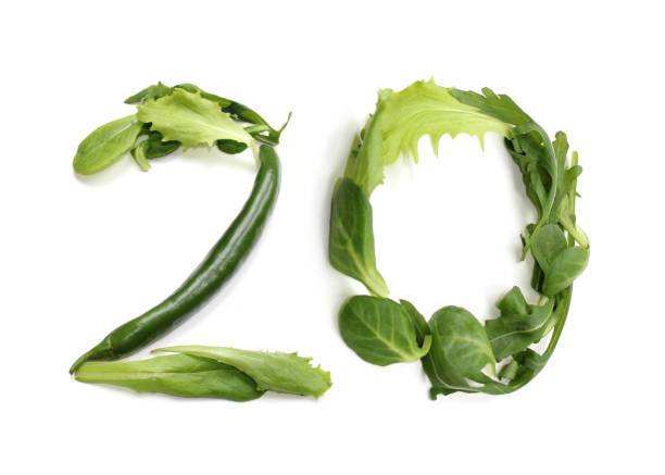green anniversary number 20, twenty, from chilli pepper and salad lettuce leaf