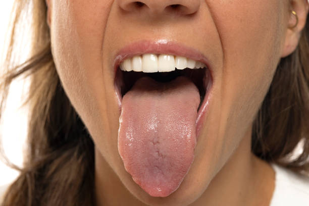 istock young woman showing tongue. 2166465385