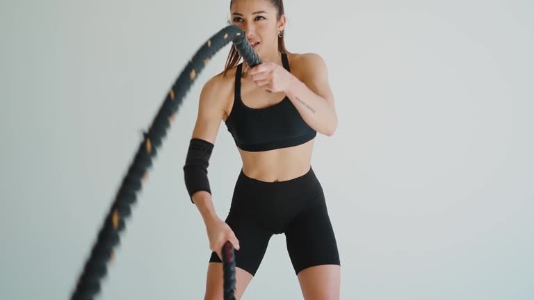 Woman doing exercises indoor with sport equipment.