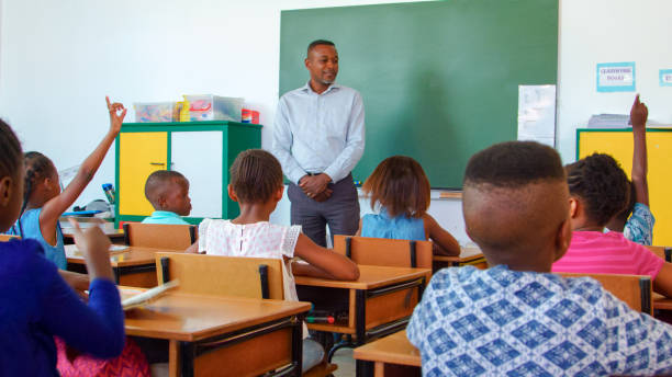 istock Teacher Engaging Young Students in Classroom Discussion at School 2166470803