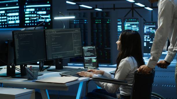 istock Woman in wheelchair doing maintenance on server room infrastructure 2166471653