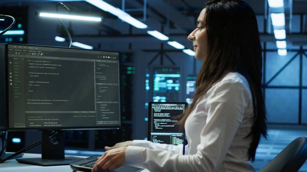 istock IT specialist in server hub starting job shift, tracking network traffic with PC 2166473093