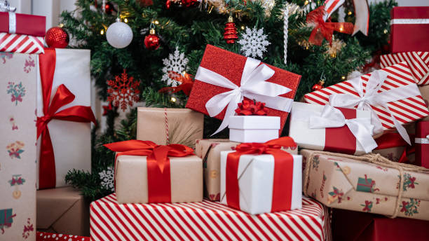 istock Gift boxes under a contemporary Christmas tree in home, adorned holiday Xmas 2166473600