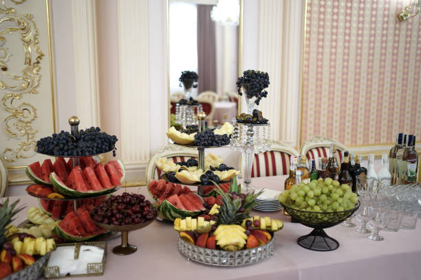 A vibrant buffet display featuring an assortment of fresh fruits, meats, and appetizers on elegantly arranged platters.