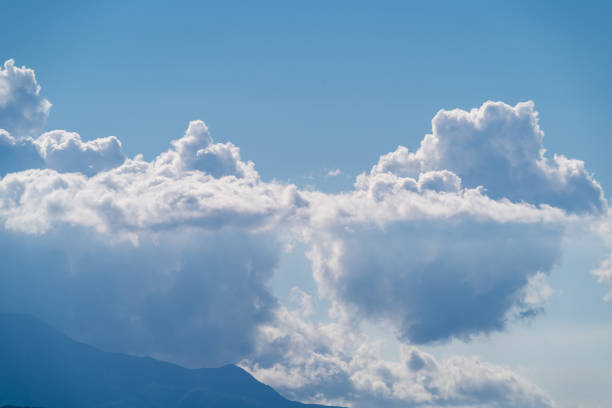 On a summer afternoon, elegant white clouds dance in the blue sky. The serene and mesmerizing scenery is a testament to the beauty of nature. Taiwan.