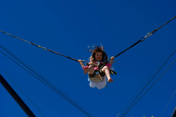 istock Young girl plays on high wire acrobatic equipment 2166477198