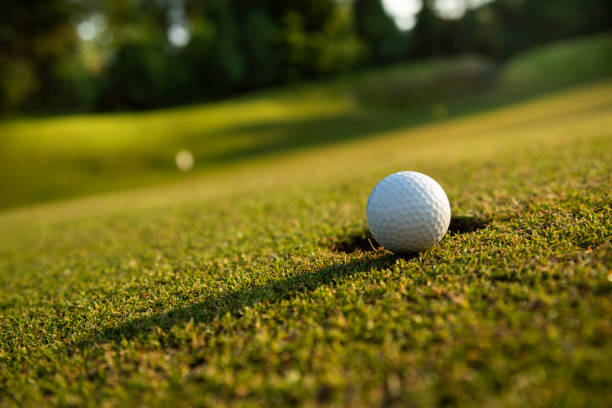 istock Closeup Golf ball on green grass on course 2166478358