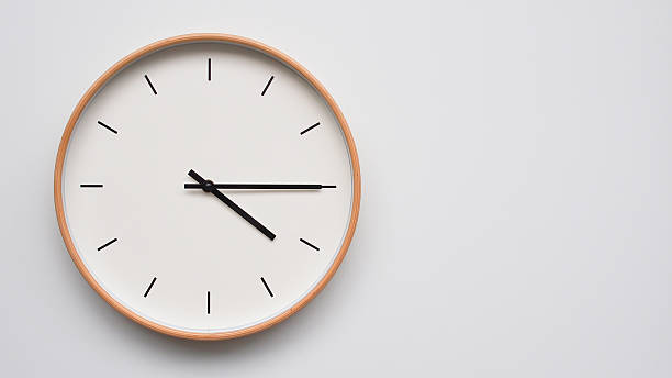 istock Minimalist wooden Wall Clock on White Wooden Surface with Space for Text  Time Set at 16.15/04.15 2166480026