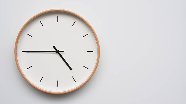 istock Minimalist wooden Wall Clock on White Wooden Surface with Space for Text  Time Set at 16.45/04.45 2166480050