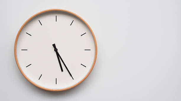 istock Minimalist wooden Wall Clock on White Wooden Surface with Space for Text  Time Set at 17.25/05.25 2166480077