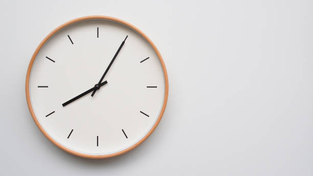 istock Minimalist wooden Wall Clock on White Wooden Surface with Space for Text Time Set at 08.05 or 20.05 2166480536