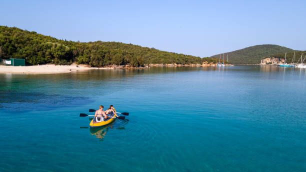 istock Active mother with daughter having fun and enjoying adventurous experience with kayak on a sunny day during summer vacation. 2166482859