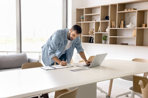 istock Focused entrepreneur man working in hurry, typing on laptop 2166484756