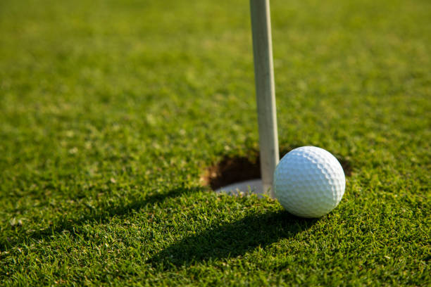 istock Closeup Golf ball on green grass on course 2166484803